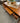 BROWN WOOD DESK w/ 3 DRAWERS, TALL NARROW LEGS