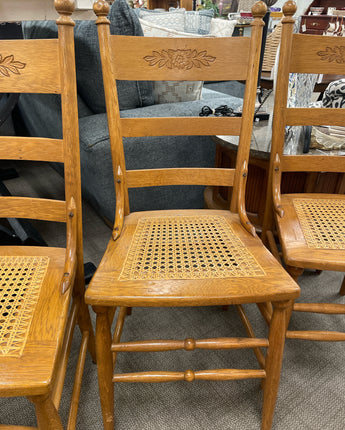 SET OF 6 SOLID OAK CHAIRS WITH CANE SEATS AND FLOWERS ETCHED ON BACK