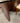 GLASS TOP, UNDULATING WAVE PATTERN WOOD BASE, 8 WOOD CHAIRS, CREAM LEATHER SEATS