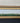 ELONGATED GOLD ORNATE FRAME W/HORSES RUNING ACROSS A MEADOW