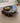 39" ROUND, BROWN LEATHER OTTOMAN, SLIDE-OUT TRAYS ON SIDE