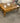 COFFEE TABLE LEATHER TOP ONE DRAWER BROWN STAIN BRASS WHEELS