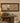 DARK WOOD FRAME WITH THREE PANELS MIDDLE IS A MIRROR & EACH END ARE A BIRD
