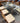GLASS TOP, UNDULATING WAVE PATTERN WOOD BASE, 8 WOOD CHAIRS, CREAM LEATHER SEATS