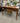BROWN WOOD DESK w/ 3 DRAWERS, TALL NARROW LEGS
