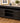BLACK DISTRESSED TV STAND, OPEN TOP SHELF, 2 GLASS DOORS, 3 SHELVES